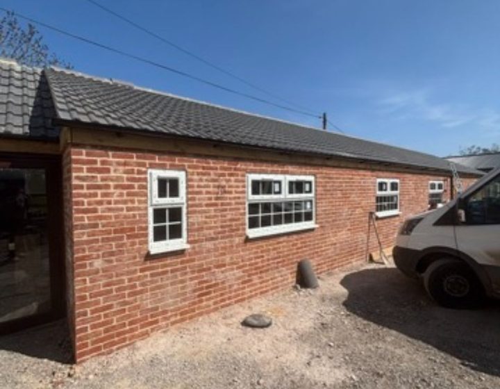 Brick extension exterior with gravel driveway